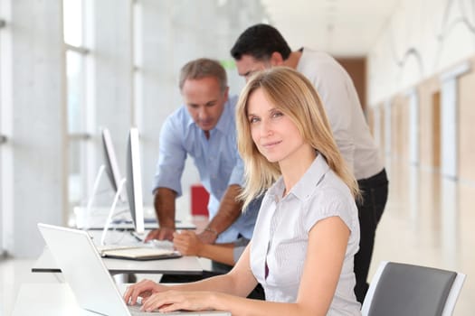 Beautiful woman working in the office on laptop computer