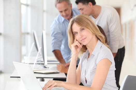 Beautiful woman working in the office on laptop computer