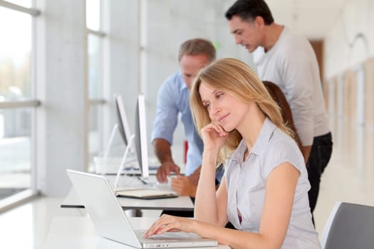 Beautiful woman working in the office on laptop computer