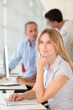 Beautiful woman working in the office on laptop computer
