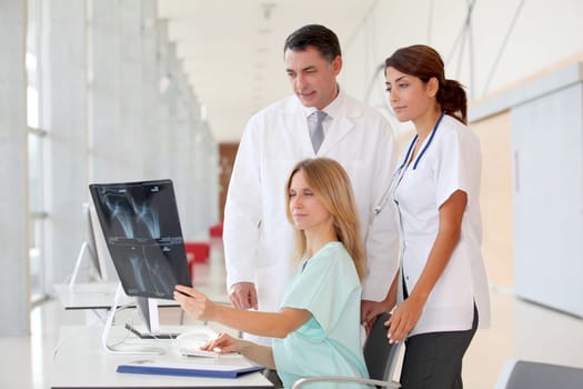 Group of medical people looking at xray
