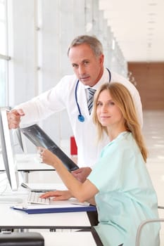 Doctor and nurse looking at x-ray
