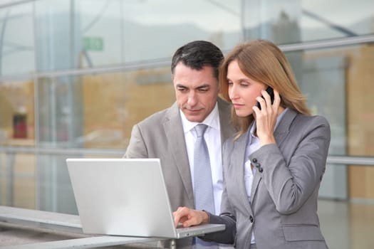 Sales people working outside modern building