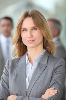 Closeup of blond businesswoman standing outside