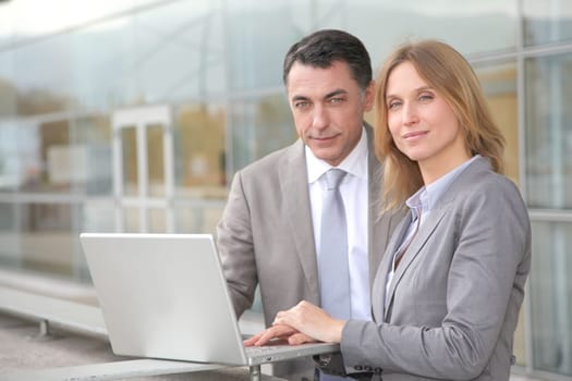 Sales people working outside modern building