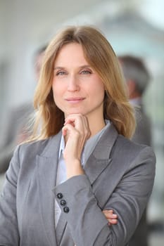 Closeup of blond businesswoman standing outside