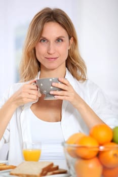 Woman having breakfast in the morning