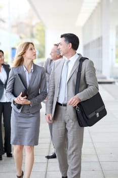 Business people walking outside a congress center
