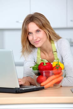 Woman in kitchen looking for cooking receipe