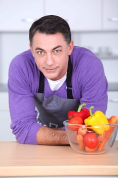 Man in kitchen with laptop computer