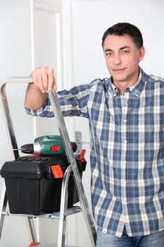 Man using electric drill at home