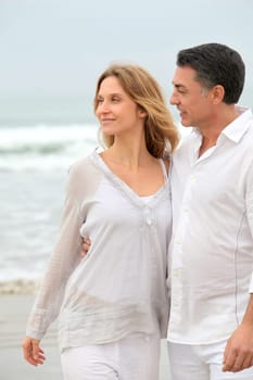 Couple walking by the beach