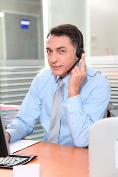 Adult man in the office talking on the phone