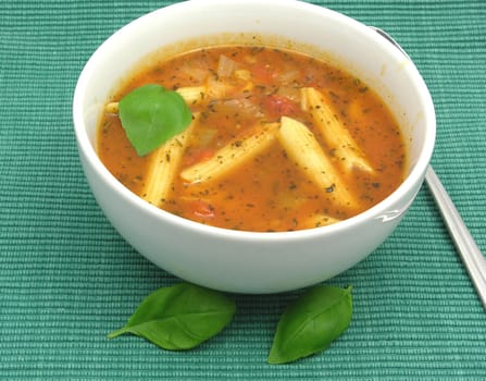 Noodle soup with tomatoes and herbs