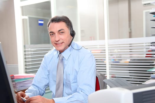 Adult man in the office talking on the phone