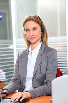 Blond office worker with headphones