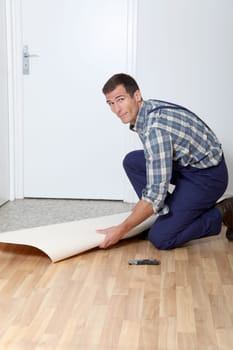 Closeup of artisan installing ground floor in room