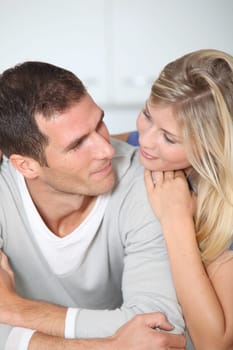 Smiling couple standing in home kitchen