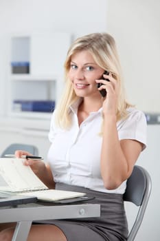 Beautiful smiling young woman working in the office