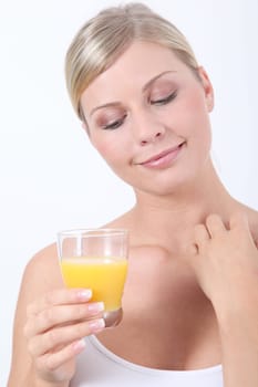 Beautiful blond woman holding glass of orange juice