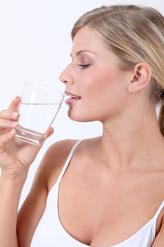 Closeup of woman holding glass of water