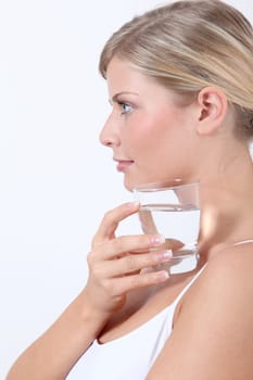 Closeup of woman holding glass of water