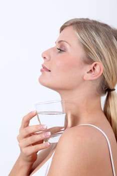 Closeup of woman holding glass of water
