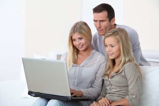 Family at home in front of computer