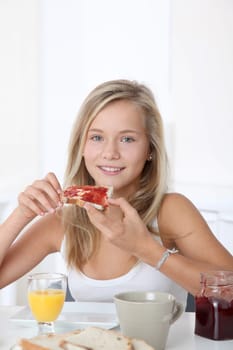Closeup of beautiful blond girl having breakfast