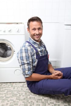 Plumber fixing broken washing machine