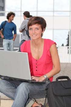 Student at college campus with laptop computer