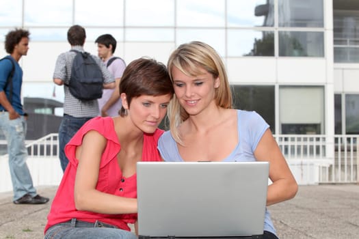 Student at college campus with laptop computer