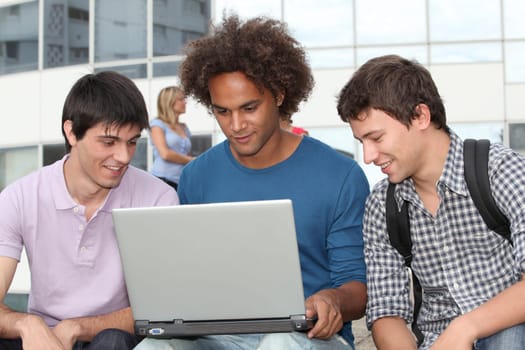 Students at college campus with laptop computer