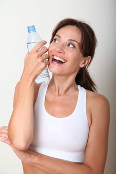 Closeup of woman drinking water after exercising