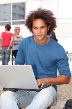 Student at college campus with laptop computer