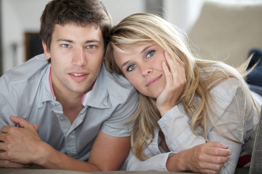 Closeup of young couple laying on couch