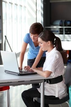 Young women working on laptop computer