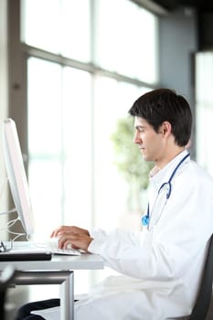 Young doctor working in front of computer