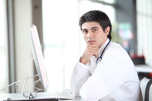 Young doctor working in front of computer
