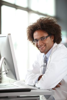 Young doctor working in front of computer