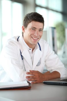Young doctor in front of laptop computer