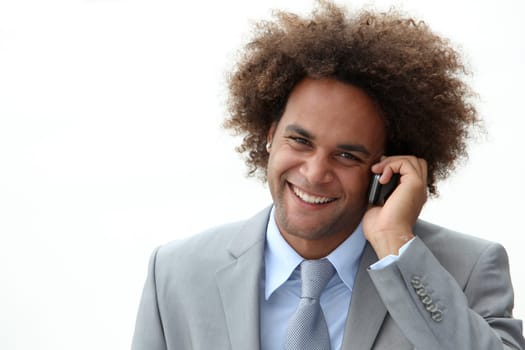 Closeup of happy young businessman on the phone