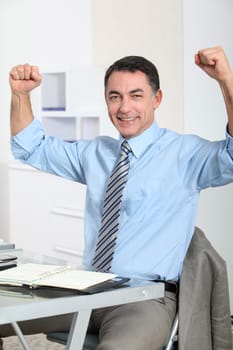 Man in the office showing positivity