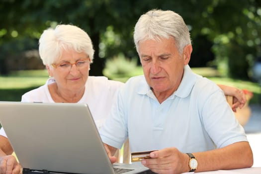 Senior couple doing online shopping