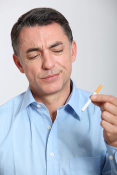 Closeup of man trying to quit smoking