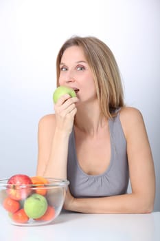 Closeup of beautiful woman holding green apple