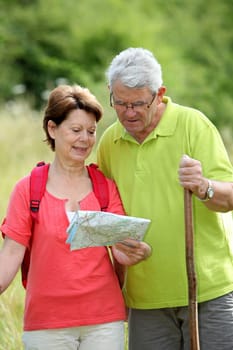 Closeup of senior couple rambling in countryside with map