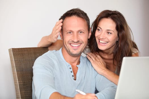 Couple at home surfing on internet