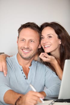 Couple at home surfing on internet