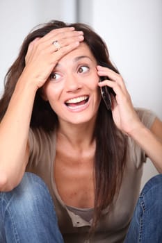 Woman talking on mobile phone at home